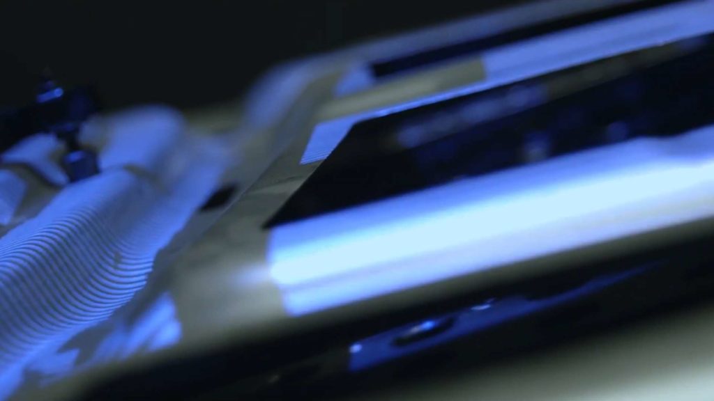 Blue structured-light from a 3D scanner projected on a metal part